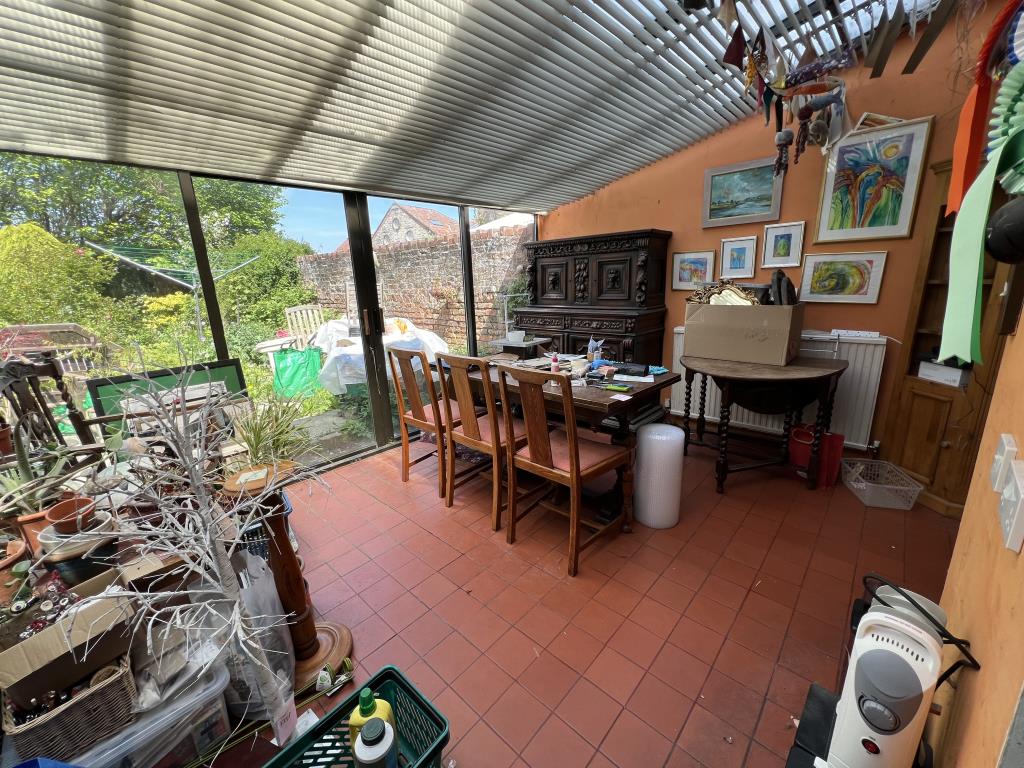 Lot: 168 - FOUR STOREY TOWN HOUSE FOR UPDATING - General view of the sunroom-conservatory looking to garden